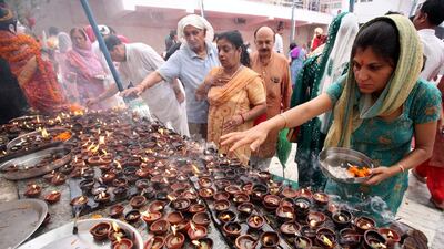 Hindu Kashmiri migrant devotees light earthen lamps as they offer prayers at Mata Kheer Bhawani Temple during the annual festival in Jammu, India. Jaipal Singh / EPA