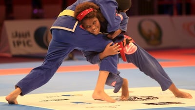Fatema Al Falahi (with yellow belt) fights Ariel Oliveira in the juvenile female yellow orange and green belt division's 50.5 kilogram class semi-final on April 20 at the Abu Dhabi World Professional Jui-Jitsu Championship 2015 at IPIC Arena, Zayed Sports City in Abu Dhabi. Ravindranath K / The National