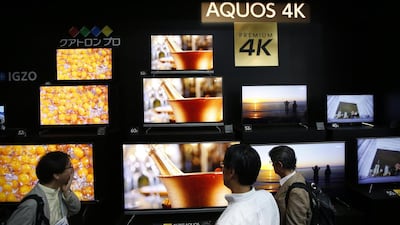 Visitors look at 4k-capable screens on display at the booth of Sharp. Issei Kato / Reuters
