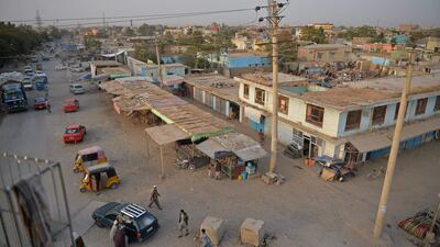 People walk past a street in Kunduz. AFP