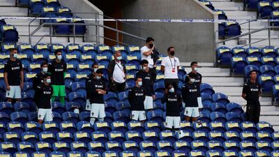 Cristiano Ronaldo goes maskless while Portugal's substitutes wear protective face masks. Reuters