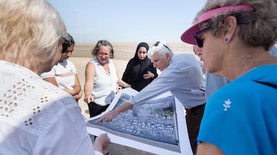 Dr Athol Yates of Khalifa University and his team examine a map of the cemetery.