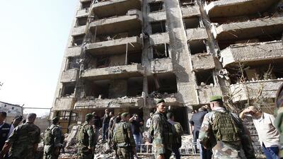 Lebanese security forces stand guard near a damaged building at the scene of a powerful blast in southern Beirut which killed at least 10 people on November 19, 2013 near the Iranian embassy, according to police and security sources. Anwar Amro / AFP