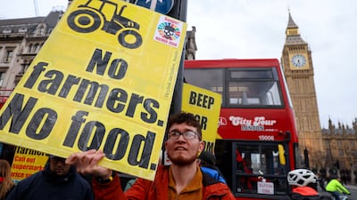 A man holds a placard outside Parliament, as part of a day of protest from food growers around the world. Reuters