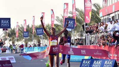 Ababel Yeshaneh crosses the finish line of RAK Half Marathon and breaks the world record in Ras Al Khaimah. AFP