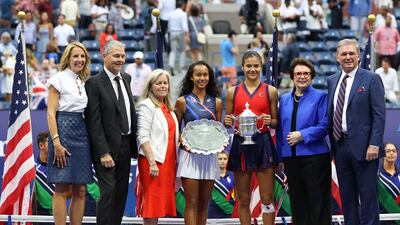 Leylah Annie Fernandez of Canada holds the runner-up trophy as Emma Raducanu of Great Britain celebrates with the championship trophy alongside Billie Jean King, Stacey Allaster, USTA Chief Executive, and USTA President Mike McNulty. AFP