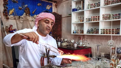 Local artisans conduct workshops in traditional metalwork, pottery, glass blowing and Arabic cloak making. Emirati craftsman Noor Ahmad is busy in his workshop in Abu Dhabi's Heritage Villlage. Victor Besa/The National