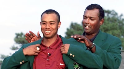 Tiger Woods is handed his second famous Green Jacket from previous year's winner Vijay Singh after the American won the 2001 Masters at Augusta National Golf Club. AFP