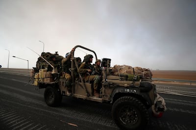 Israeli soldiers patrol on the roads near the border with Gaza. EPA