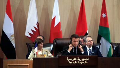 Mr Macron takes part in discussions. EPA