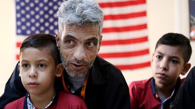 Flanked by his sons Farouq, 8, and Hamzeh, 12, Syrian refugee Nadim Fawzi Jouriyeh, 49, is speaking to to reporters at the Amman, Jordan office of the International Organization for Migration on August 28, 2016. The six-member Jouriyeh family will head to San Diego, California, as part of a year-long programme to resettle 10,000 Syrian refugees in the United States. Raad Adayleh/AP Photo