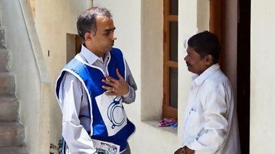Ashwin Mahesh goes door to door while campaigning in Bengaluru. Amirtharaj Stephen for The National