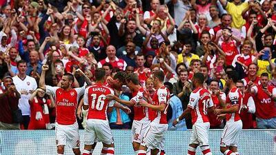 Olivier Giroud of Arsenal is congratulated by team-mate Nacho Monreal and Aaron Ramsey during the FA Community Shield match between Manchester City and Arsenal at Wembley Stadium on August 10, 2014 in London, England. (Photo by Clive Mason/Getty Images)