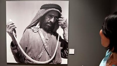 Visitors look at an image from the Roots of the Union photo exhibit at the UAE Pavilion on Saadiyat Island. Silvia Razgova / The National