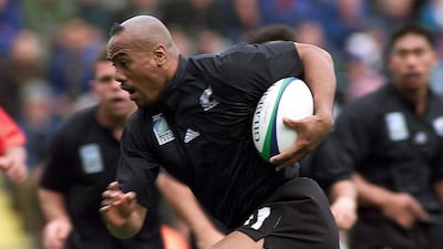 Jonah Lomu tucks the ball under his arm to run and score the All Black’s first try against Tonga during their 1999 Rugby World Cup Group B match at Ashton Gate. Dylan Martinez / Reuters