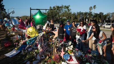 Well-wishers place mementos the day students and parents arrive for voluntary campus orientation at the Marjory Stoneman Douglas High School, for the coming Wednesday's reopening, following last week's mass shooting in Parkland, Florida, February 25, 2018. Angel Valentin / Reuters
