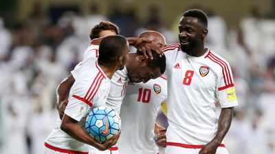 Ahmed Khalil, left, is congratulated by teammates after scoring the winner in a 2-1 win against Saudi Arabia. Chris Whiteoak / The National