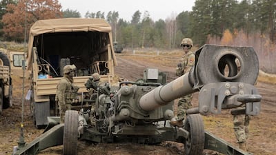 Soldiers get ready to use test a US Army M777 howitzer, scores of which are being sent to Ukraine, during Nato exercises at Orzysz training ground, north-eastern Poland. EPA