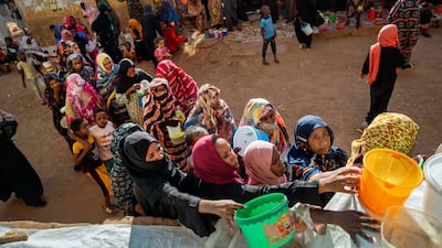 Sudanese families line up for food at a communal kitchen in Omdurman, Sudan. Getty Images