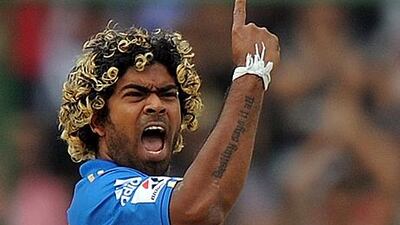 Lasith Malinga celebrates the wicket of Delhi's David Warner in his blistering bowling spell of five for 13 for the Mumbai Indians.