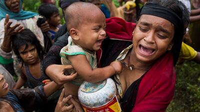 A Rohingya woman breaks down after a fight erupted during food distribution by local volunteers at Kutupalong, Bangladesh. The massive refugee camp in Kutupalong was set up in the early 90s to accommodate the first waves of Rohingya Muslim refugees who started escaping convulsions of violence and persecution in Myanmar. Bernat Armangue / AP Photo