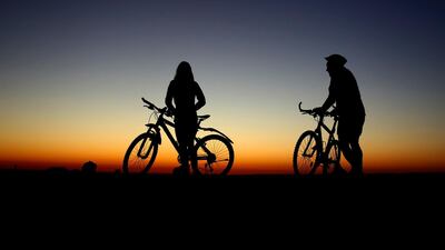 Cyclists seen just before sunrise in Munich, Germany. AP Photo