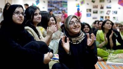 From left, Huda Farooq, Mahwish Javaid and Munazzah Abbas watch dancers perform as part of celebrations for Pakistan’s National Day at the University of Wollongong yesterday.