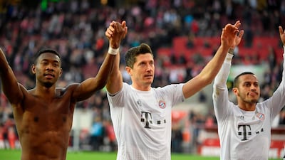 Left to right: Bayern Munich's David Alaba, Robert Lewandowski and Thiago Alcantara celebrate after the win at Cologne. AFP