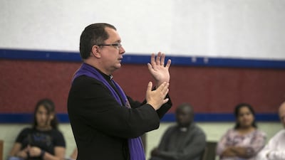 Reverend Canon Andrew Thompson leads a sermon at St Andrew's Church in Abu Dhabi. (Silvia Razgova / The National)