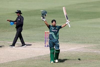 Pakistan opener Shahzaib Khan raises his bat after reaching his century at the Dubai International Cricket Stadium. CREIMAS for Asian Cricket Council