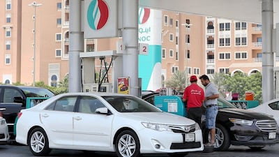Cars fill up at an Enoc petrol station in Dubai. The price of petrol in the UAE is set to rise. Pawan Singh / The National