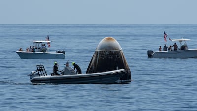 Support teams and recreational boaters arriving at the SpaceX Crew Dragon Endeavour spacecraft shortly after it landed. EPA