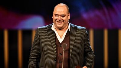 Egyptian actor Mohamed Mamdouh holds the Best Actor Award during the closing ceremony of the 43rd Cairo International Film Festival. AFP