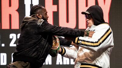 Heavyweights Wilder and Fury shove each other on stage. EPA
