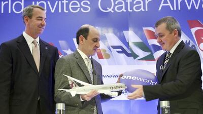 CEO of Qatar Airways Akbar Al Baker, centre, exchanges a gift with International Airlines Group chief executive Willie Walsh. Seth Wenig / AP Photo