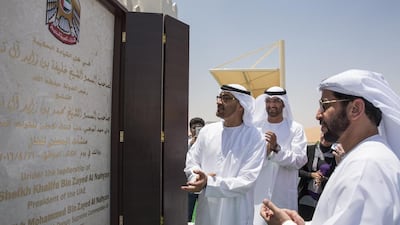 Sheikh Mohammed bin Zayed, left, Crown Prince of Abu Dhabi and Deputy Supreme Commander of the UAE Armed Forces, Sultan Al Jaber, centre, chief executive of Adnoc, and Sheikh Hamdan bin Zayed, the Ruler’s Representative in the Western Region, unveil a commemorative plaque during the inauguration of the Al Hosn facility. Ryan Carter / Crown Prince Court - Abu Dhabi