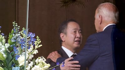 US President Joe Biden is embraced by Japan's ambassador to the US Tomita Koji on Saturday, a day after Japan's former prime minister Shinzo Abe was fatally shot. Reuters