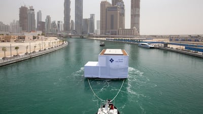 The first water home makes its way up Dubai Water Canal. Courtesy Dubai Properties