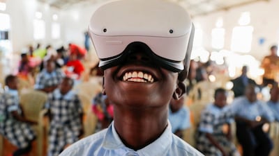 Francis Mwangi, 13, uses an Oculus virtual reality headset in Kenya to virtually visit Buckingham Palace during a celebration of Queen Elizabeth II's platinum jubilee. Reuters