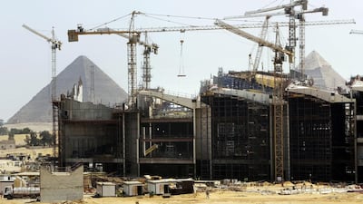 Cranes work at the site of the Grand Egyptian Museum near the Giza Pyramids on the outskirts of Cairo. Amr Nabil / AP Photo