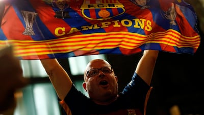 A Barcelona supporter celebrates at the end of their Copa del Rey final against Sevilla in Barcelona. Pau Barrena / AFP