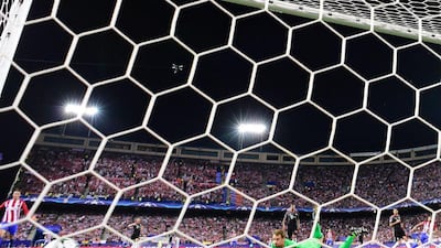 Bayern Munich goalkeeper Manuel Neuer, right, looks at the ball after Atletico Madrid’s Yannick Carrasco scored. Pierre-Philippe Marcou / AFP