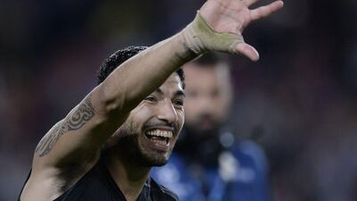 Barcelona's Luis Suarez smiles and waves to fans after the team's 2-1 win over Bayer Leverkusen on Tuesday night in the Champions League. Josep Lago / AFP