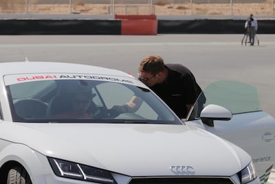 Adjusting the seat, steering wheel, seat belt and head rest. Courtesy Dubai Autodrome