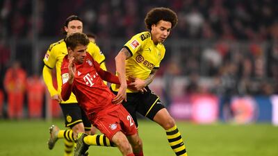 Bayern's Thomas Mueller and Dortmund's Axel Witsel tussle for the ball. EPA