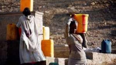 Women carry water from a well in Ethiopia: the global crisis could offer a window to address worldwide challenges.