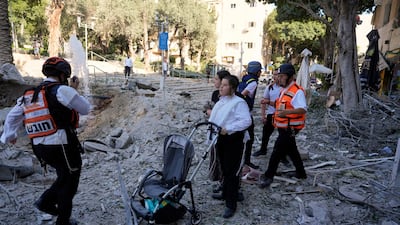 Rescue workers evacuate residents from the site where a missile launched from Iran struck Haifa, Israel, on Sunday. AP