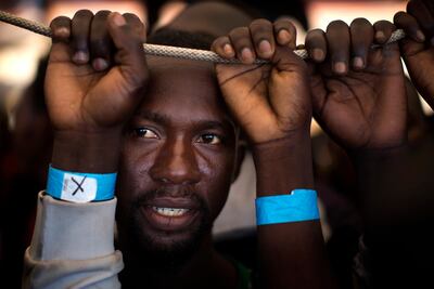 Nigerian Samuel, 25, waiting for his turn to leave the Golfo Azzurro rescue vessel, after being rescued on June 17, 2017 from a packed boat from Libya, by members of Proactive Open Arms, as they arrive at the port of Pozzallo, south of Sicily, Italy. Emilio Morenatti/AP Photo