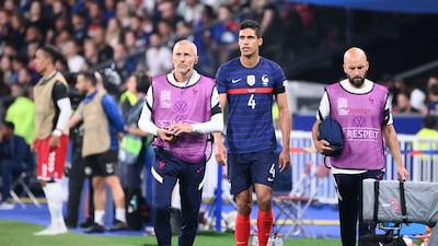 France's defender Raphael Varane walks off after picking up an injury. AFP