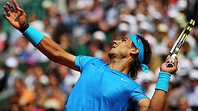 Rafael Nadal serves during his match against John Isner yesterday at the French Open. The Spaniard was forced to come from behind to win in five sets against the American.
